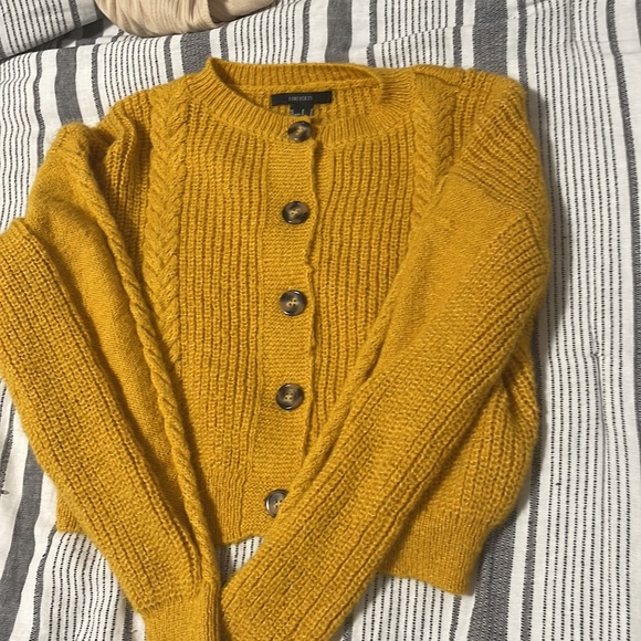 The color of the cardigan is yellow with buttons down the middle. - Picture 5 of 7